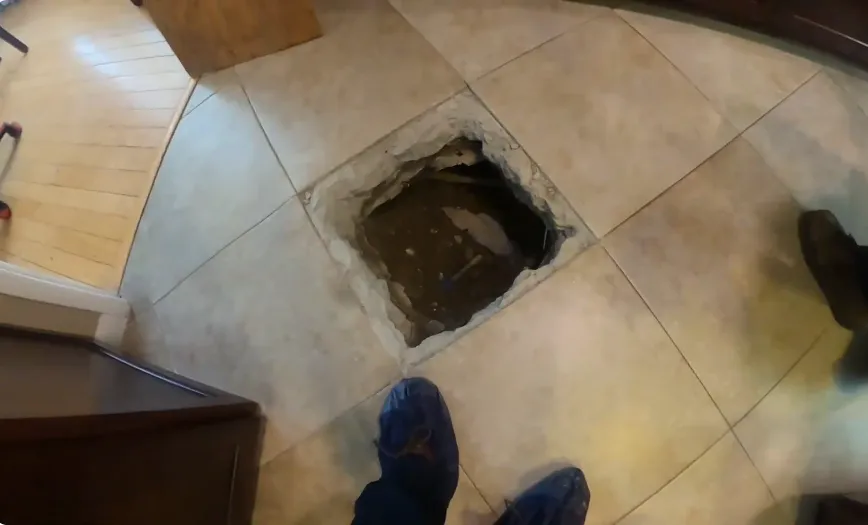 Slab leak access opening in a tiled floor, Plant City