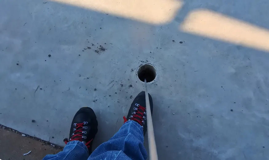 Technician pinpointing a leak beneath a concrete slab