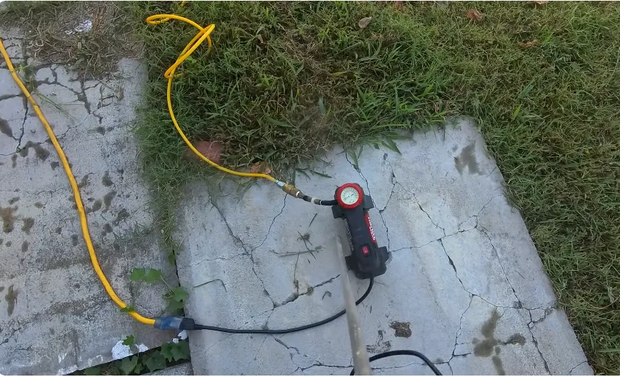 Pressure testing a water line with a compressor and gauge